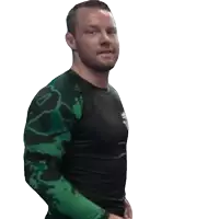 a man wearing a green and black shirt with a lion on it