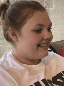 a girl wearing a white t-shirt with the word just on it