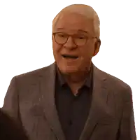 a man in a suit and glasses is smiling with his mouth open