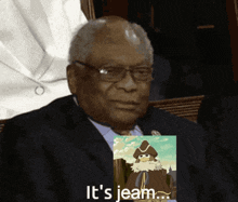 a man in a suit is holding a picture of a man with the words it 's jeam
