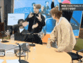 a group of people standing around a table with a sign that says radio