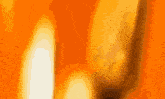 a close up of a candle flame on a orange background