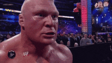 a man with a wrestling logo on his chest