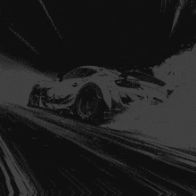 a silver letter z is on a black background with a car in the background