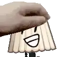 a hand is holding a cartoon character with a face on it 's head .