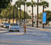 a person riding a bike down a street with the words dhahran saudi arabia written on the bottom