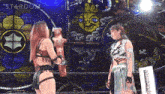two women wrestling in front of a stained glass window with stardom written on it