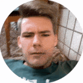 a man in a green shirt is in a circle with a tiled wall behind him