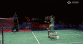 two players on a badminton court one of whom has the number 33 on his jersey