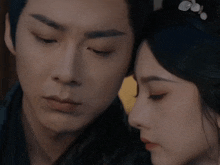 a man and a woman are looking at each other with their eyes closed