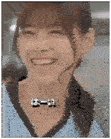 a close up of a woman 's face with a ponytail smiling .