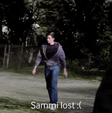 a man is walking down a road with the words sammi lost written on the bottom