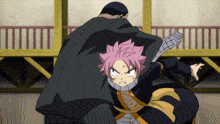 a man in a black cape holds a girl with pink hair