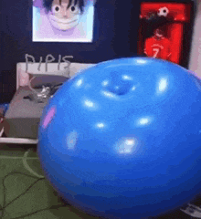 a blue balloon with a hole in it is sitting on the floor in a bedroom .