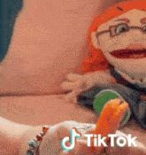a person holding a stuffed animal next to a tiktok logo