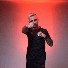 a man in a black shirt with the word adidas on the sleeve