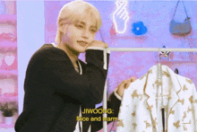 jiwoong is holding a white jacket and says nice and warm