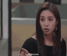 a woman covering her mouth with her hand and the name murulina is on the bottom