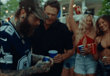 a man wearing a cowboys jersey is standing in a crowd