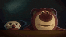 a clown and a teddy bear with disney pixar written on the bottom right