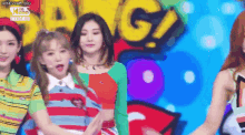 a group of girls are standing next to each other on a stage .