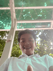 a young man with braces on his teeth is smiling