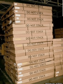 a stack of boxes that say do not stack