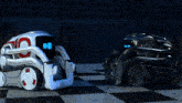 two robots are sitting on a checkered floor and one has the number 10 on its head