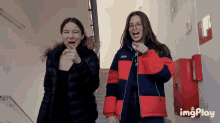 two girls are standing next to each other and one has a jacket that says a.p.m. on it