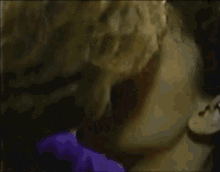 a man and a woman kissing in a dark room
