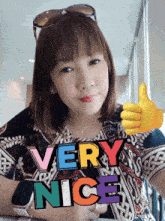 a woman giving a thumbs up with the words very nice written on her chest