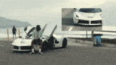 a man is sitting in a white sports car with the door open