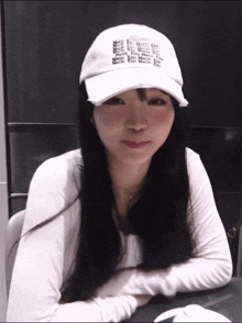a woman wearing a white baseball cap with the word coca cola on it