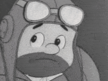 a cartoon character wearing a helmet and goggles looks sad