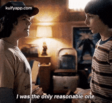 two young men are standing next to each other in a room and one of them is saying `` i was the only reasonable one . ''