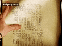a person is holding a piece of paper that says kulfyapp.com