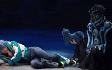 a person holding a stuffed animal while another person sits on the floor