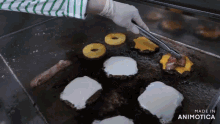a bunch of food is cooking on a grill and the words made in animatica are on the bottom right