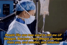 a surgeon wearing a mask and gloves is talking to another surgeon