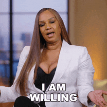 a woman says i am willing in a white jacket