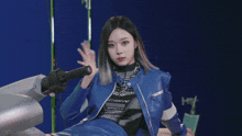 a woman wearing a blue jacket that says isbhy sport
