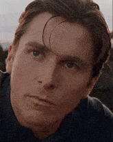 a close up of a man 's face with a serious look