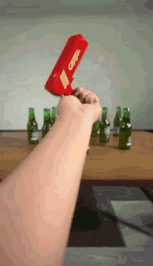 a person is holding a red box that says coca-cola on it
