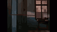 a hallway with a window and a table in the middle