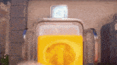 a close up of a yellow container with a circle in the middle