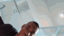 a blurry picture of a man 's face with a white ceiling in the background