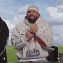 a man with a bandage on his head is wearing a white hoodie that says miami on it