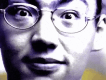 a close up of a man 's face wearing glasses