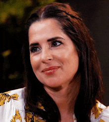 a close up of a woman 's face with a smile