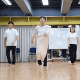 a group of people dancing in front of a white board that says suspect